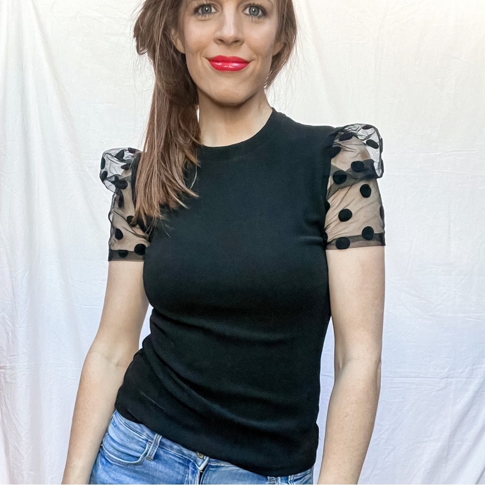 Black fitted top with mesh polka dot sleeves